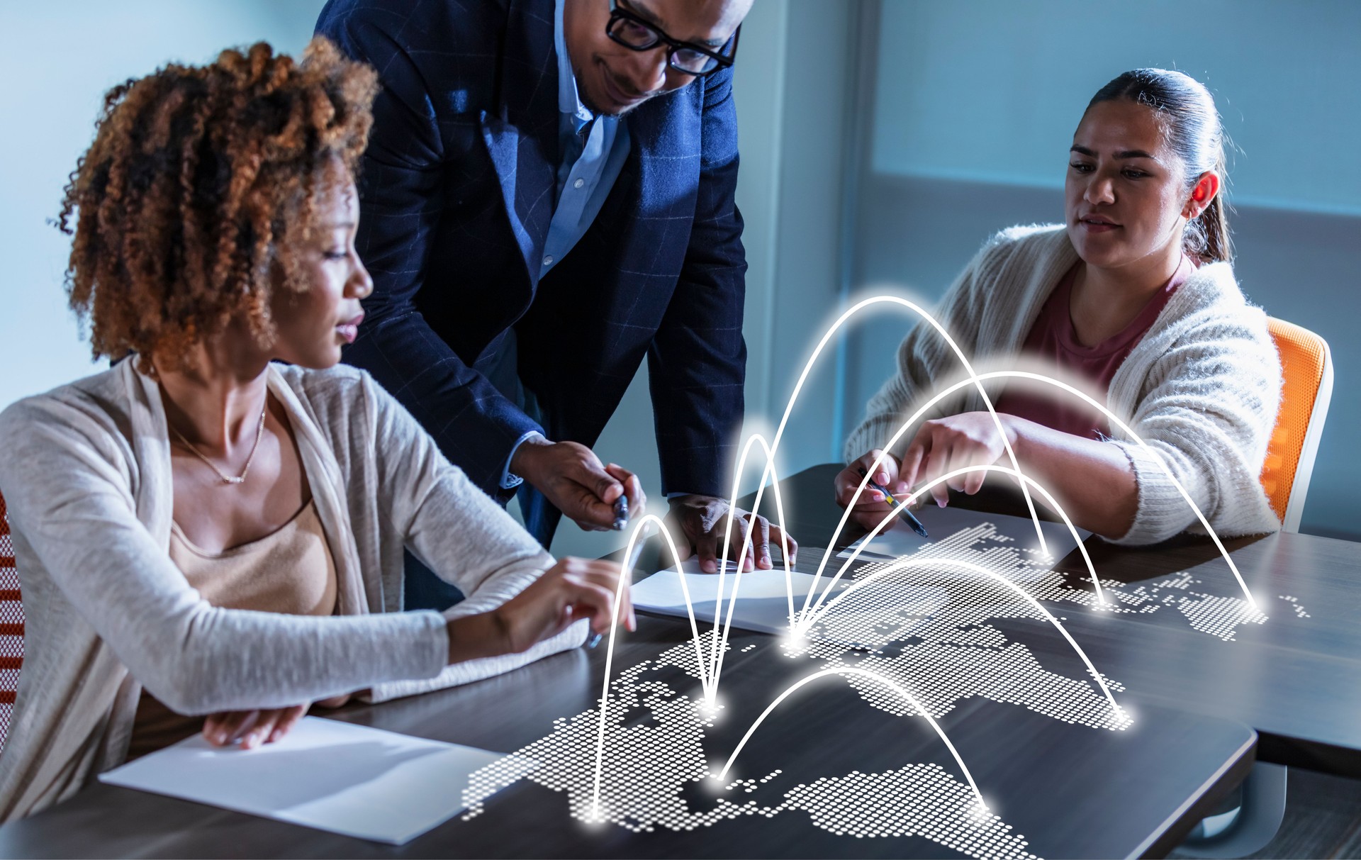 Multiracial business people in meeting reading papers